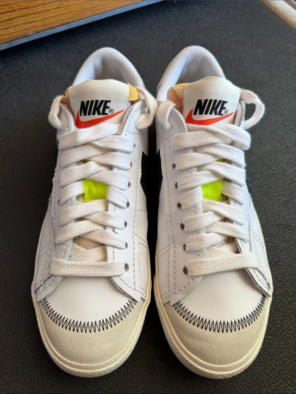 Nike White Sneakers with Neon Yellow Tongue Tab and Orange Swoosh